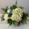 White and green blooms with Christmas greenery and accents in a 6"
