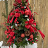 BEAUTIFUL TREE HIGHLY DECORATED WITH PINECONES AND A BEAUTIFUL RED RIBBON, ALONG
