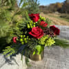Brighten the season with our Holiday Radiance arrangement. Featuring bold red roses