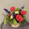 This beautiful basket full of fresh flower blooms also includes a living