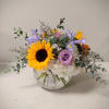 A low and lush bubble bowl filled with Sunflowers, Roses, Hydrangea and