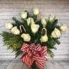 Snowy White Roses adorned with Christmas greens and candy canes in a