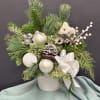 This heartwarming holiday arrangement blends winter elegance with a touch of whimsy.