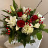 Vase arrangement of a selection of red and white flowers accented with
