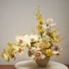 An all-yellow floral arrangement designed with a clean, modern aesthetic. 
Featuring seasonal