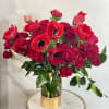 This stunning arrangement of red monochromatic flowers, carefully selected to capture the