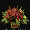 A luxurious floral arrangement featuring premium garden roses, seasonal berries, and lush