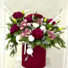 A rich and festive arrangement featuring deep burgundy blooms, soft pink cymbidium