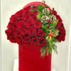 A striking dome of velvety red roses arranged in a bold red