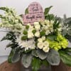 A lovely arrangement of carnations, spray roses, cushion mums, green buttons, alstroemeria