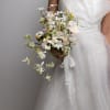 A cascading bridal bouquet with a soft, whimsical movement, featuring subtle, unique
