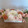 Soft Embrace is a serene and elegant floral arrangement that brings a