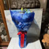 This is a classic red, white, and blue hand-tied bouquet with a