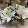 Pure white amaryllis or Asiatic lily roses and orchids with a succulent