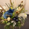 Handcrafted floral arrangement featuring fresh blue flowers, mixed seasonal blooms designed for