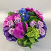 Lush luxurious collection of purple and green hydrangea, lavender rose blossoms, orchid