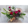Beautitful Christmas arrangement with Peonies, Orchids, Protea, and roses. It is accented