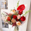 This exquisite bouquet, features velvety-red roses, exotic Anthuriums and peachy garden roses.
Comes