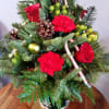 An arrangement of a mini Christmas tree with candy cane treats.