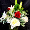 Red and white roses with Queen Anne's lace and evergreen in a