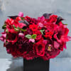 This striking floral arrangement is a lush, modern composition designed to make