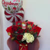 Celebrate the holiday season with Christmas Bloom Deluxe, an elegant floral arrangement