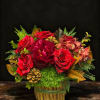 A rich and elegant winter floral arrangement featuring premium red roses, lush