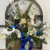 Blue and silver holiday arrangement, in silver vase, tall and elegant. 