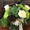A pine cone arrangement with succulent and white roses, 