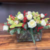 Merry arrangement blends classic elegance with seasonal warmth. Crisp white roses and