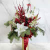 A luxurious holiday arrangement designed in a tall gold vase, featuring dramatic