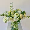 A lovely flower arrangement in neutral white and creamy yellow color tones