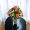 Beautiful orange yellowish roses with baby breath and greenery 