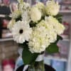 fresh white flowers in glass vase 