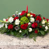 A festive long holiday centerpiece designed to brighten any table. Showcasing a