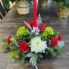 Fresh seasonal flowers and holiday greens with a single candle the perfect