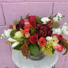 A fresh and festive floral centerpiece made up of florals which may