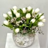 A fresh and timeless arrangement of creamy white tulips nestled among lush