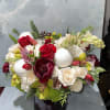 This arrangement is a luxurious winter centerpiece that blends classic romance with
