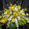All predominantly  yellow flowers &mdash;roses, mokara orchids, solidago and  touches