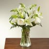 Asiatic lilies accented by lush greens arranged in a clear glass 8"