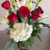 White Hydrangea, red Roses, white Lilies, and greenery make this a class