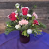 A warm, romantic mix of red roses and soft seasonal flowers, perfect