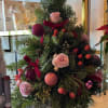 Celebrate the season with this elegant holiday evergreen tree arrangement. Designed with