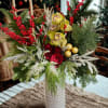 Fresh holiday greens, Christmas berries, Roses and a touch of ornaments stand