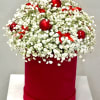 A festive and enchanting arrangement featuring a cloud of fresh white baby&rsquo;s