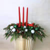A traditional Christmas centerpiece crafted with crisp evergreens, red berries, white and