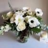 A gathering of pure whites, featuring Amaryllis and Italian Mistral Anemones. A