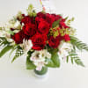 A stunning bouquet of 25 premium roses surrounded by lush seasonal foliage