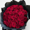 Thirty-nine rich red roses wrapped in dramatic black paper bold, modern, and